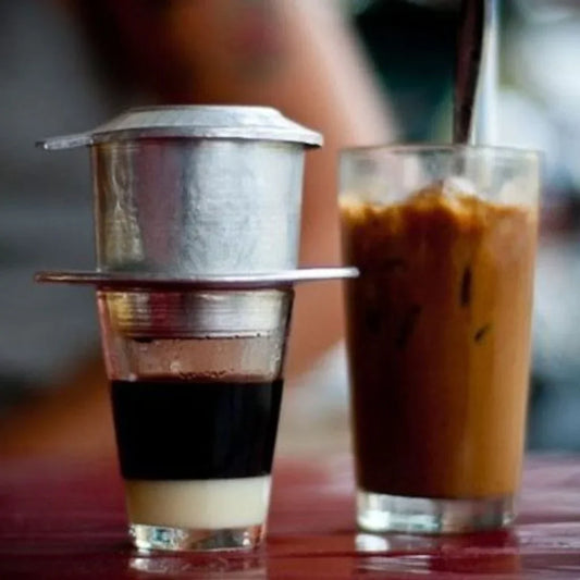 Glass of iced Vietnamese coffee with condensed milk ribboning.