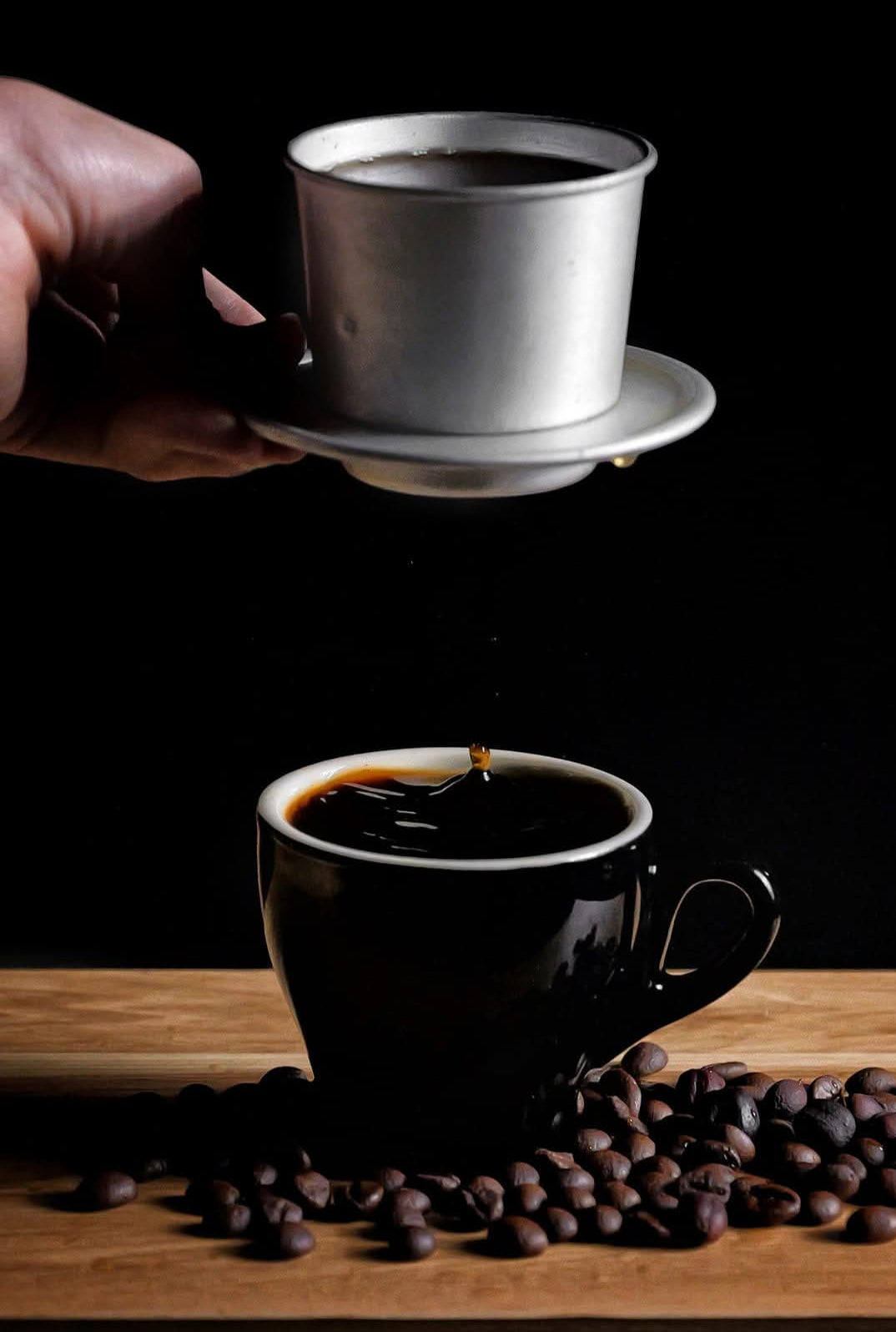 Vietnamese phin filter brewing coffee over 